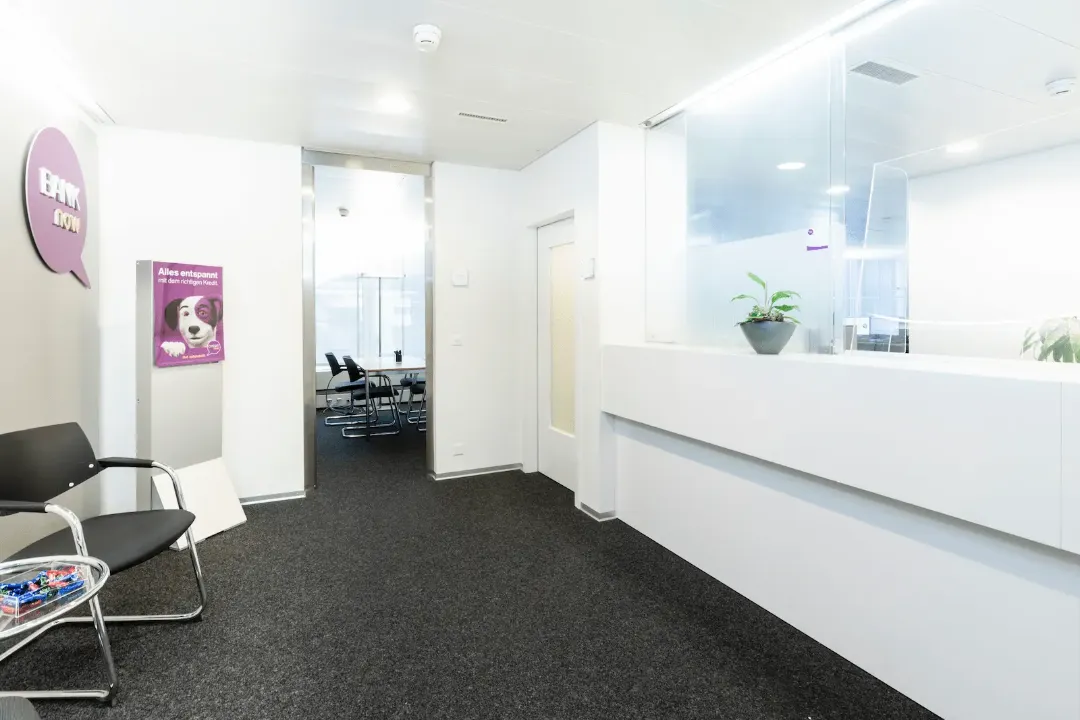 Wartebereich der BANK-now Filiale Baden mit Stühlen und Blick Richtung Empfang.